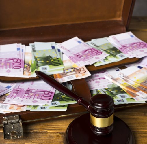 close up suitcase with money judge gavel